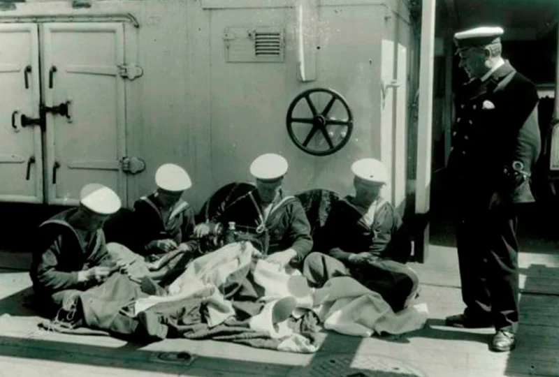 A group of men sitting on the ground.