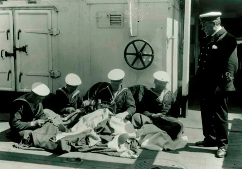 A group of men sitting on the ground.